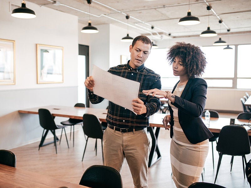 man and woman looking at documents